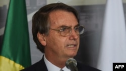 Brazil's President Jair Bolsonaro delivers a speech during the inauguration of the new Director of the Brazilian side of Itaipu binational hydroelectric dam, former Brazilian Defense Minister and Army General Joaquim Silva e Luna, Feb. 26, 2019 in Itaipu,