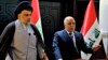 In this photo provided by the Iraqi government, Iraqi Prime Minister Haider al-Abadi, right, and Shiite cleric Muqtada al-Sadr hold a press conference in the heavily fortified Green Zone in Baghdad, Iraq, May 20, 2018. 