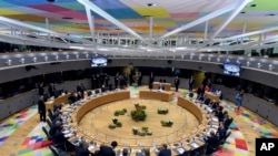 FILE - European Union leaders attend a roundtable meeting at an EU summit in Brussels, March 21, 2019.