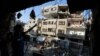 Palestinians inspect the rubble of a house after it was hit by an Israeli missile strike in Gaza City, July 10, 2014.
