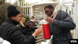 As head of a youth volunteer group in the Essence area outside Paris, Gaetan Ziga is up before dawn at least once a week to serve coffee to immigrants immigrants lined up to get their legal papers.