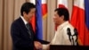 Philippine President Rodrigo Duterte and visiting Japanese Prime Minister Shinzo Abe shake hands after a joint statement at the presidential palace in Manila, Philippines, Jan. 12, 2017.