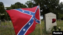 Una bandera de la Confederación ondea junto a una lápida en el cementerio de Magnolia, en Charleston, Carolina de l Sur, en junio de 2015.