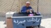 FILE - An Iraqi street currency exchanger counts banknotes in Baghdad, Aug. 8, 2015.