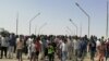 FILE: Sudanese demonstrators march and chant during a protest against the military takeover, in Atbara, Sudan, Oct. 27, 2021 in this social media image.