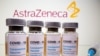 FILE PHOTO: Vials and medical syringe are seen in front of AstraZeneca logo in this illustration