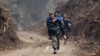 Zhang Bin, a Chinese People's Liberation Army soldier, carries a 60-year-old survivor down a stretch of road, Lingguan township, April 22, 2013.