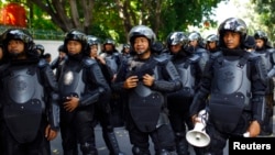 Indonesian policemen are deployed outside the Burmese embassy during a protest by Indonesian Muslim hardline groups in Jakarta, May 3, 2013. 
