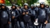 Indonesian policemen are deployed outside the Burmese embassy during a protest by Indonesian Muslim hardline groups in Jakarta, May 3, 2013. 