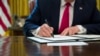 President Donald Trump signs an executive order to increase sanctions on Iran, in the Oval Office of the White House, June 24, 2019, in Washington. 