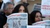 Demonstrators hold placards and copies of the Cumhuriyet daily newspaper as they stage a protest outside a court where the trial of about a dozen employees of the newspaper on charges of aiding terror groups, continues in Istanbul, Oct. 31, 2017.
