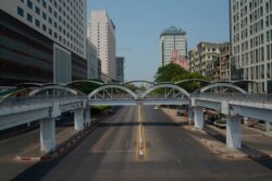 A car is seen on an empty street in downtown Yangon, Myanmar, March 24, 2021, during what anti-coup protesters called a "silent strike."