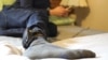 Jose, who did not want to use his real name, is an asylum seeker from Honduras. He wears a GPS monitor on his right leg, which he must charge for two hours every day.
