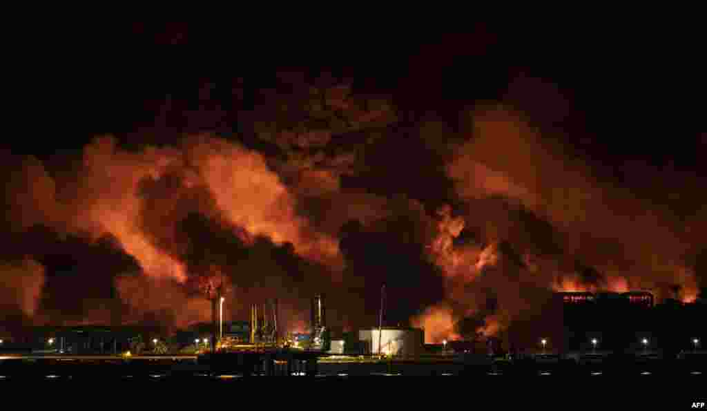 Las llamas no pudieron ser contenidas y se extendieron la madrugada del sábado a otro de estos contenedores, provocando explosiones. (Foto de YAMIL LAGE / AFP)