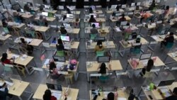 Registered teachers wearing face masks and shields against Covid-19, conduct a teleconferencing with stuggling students helping them in their school lessons through online distant learning at a local government-sanctioned online tutorial class in Taguig C