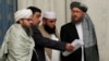FILE - Members of a Taliban delegation take their seats during peace talks on Afghanistan in Moscow, Russia, Nov. 9, 2018.