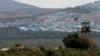 FILE - A Turkish military armored vehicle patrols on the border line located opposite the Syrian town of Atimah, Idlib province, in this picture taken from Reyhanli, Hatay province, Turkey Oct. 10, 2017.