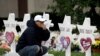 FILE - A person pauses in front of Stars of David with the names of those killed in a deadly shooting at the Tree of Life Synagogue, in Pittsburgh, Pennsylvania, Oct. 29, 2018. 