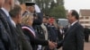 French President Francois Hollande (R) shakes hands with the mayor of Calais, Natacha Bouchart, during a meeting with officers of the French Gendarmerie in Calais as part of his visit to the northern French port which is home to the "Jungle" migrant camp, France, Sept. 26, 2016.