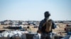 Special forces of the Syrian Democratic Forces keep watch in the vicinity of al-Hol camp, in Syria's northeast, March 30, 2021.