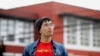 In this March 31, 2020, photo, Kyle Navarro poses in San Francisco. The school nurse was recently unlocking his bicycle when an older white man called him a racial slur and spat at him. 