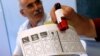 A person holds a ballot paper at a polling station during a mayoral election re-run in Istanbul, Turkey, June 23, 2019.
