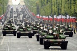 French soldiers parade in military vehicles during the Bastille Day military parade down the Champs-Elysees avenue in Paris, July 14, 2019.