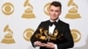 Sam Smith poses in the press room with the awards for best new artist, best pop vocal album for “In the Lonely Hour”, song of the year for “Stay With Me”, and record of the year for “Stay With Me” at the 57th annual Grammy Awards at the Staples Center on 