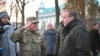 German Defense Minister Boris Pistorius, right, and Colonel Hennadiy Kovalenko are seen after laying flowers on the memorial to the "Maidan Heroes" at Maidan square in Kyiv on Nov. 21, 2023.