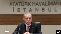 Turkey's President Recep Tayyip Erdogan talks to members of the media regarding the local elections, in Istanbul, Monday, April 8, 2019, prior to his departure for Russia. 