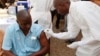 FILE - A health worker prepares to inject a man with an Ebola vaccine in Conakry, Guinea, March 7, 2015.