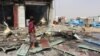 A man stands at the scene of an airstrike that hit a truck at a gas station in Abss, Yemen, April 24, 2018. 