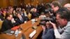 Irish rock star and activist Bono, left, speaks with Deputy Secretary of State Tony Blinken on Capitol Hill in Washington prior to a Senate subcommittee hearing on the causes and consequences of violent extremism, April, 12, 2016.