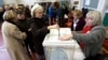 A woman casts her ballot at the first round for the French left's presidential primaries ahead of the 2017 presidential election, in Marseille, southern France, Jan.22, 2017.