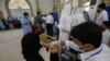 A resident receives a dose of coronavirus disease (COVID-19) vaccine at a vaccination facility in Karachi, Pakistan, Aug. 4, 2021.