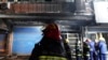 Firefighters work at the site of a building fire in Xinyu City, east China's Jiangxi Province, Jan. 24, 2024. 