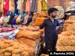 Vendor hawks traditional food items at a market in a Muslim dominated neighborhood in Delhi.