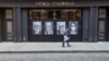 A man wearing a face mask to protect against the coronavirus walks past a closed Dolce & Gabbana store May 7, 2020, in the Soho neighborhood of Manhattan in New York. 