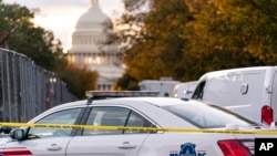 FILE - Washington Metropolitan Police investigate near the Supreme Court and Capitol after reports of a suspicious vehicle in which two men and a woman were detained with guns, Oct. 19, 2022.