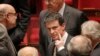 French prime minister Manuel Valls, center, leaves the France's National Assembly, in Paris, Wednesday, Feb. 10, 2016. French lawmakers voted on a divisive bill aimed at changing the constitution to introduce the possibility of revoking the citizenship of people convicted on terrorism charges in the wake of the Paris attacks.