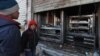 Syrian boys look at the destroyed grills outside a shuttered restaurant that was the site of a suicide attack targeting U.S.-led coalition forces in Manbij, Syria, the previous day, on Jan. 17, 2019. Islamic State claimed responsibility for the attack. 
