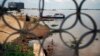 A fisherman casts his net in the Mekong river in Phnom Penh, Cambodia, Nov. 7, 2012. 