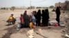 FILE - People fill buckets with water from a well that is alleged to be contaminated water with the bacterium Vibrio cholera, on the outskirts of Sanaa, Yemen, Jul. 12, 2017. 