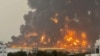 TOPSHOT - A handout picture obtained from Yemen's Huthi Ansarullah Media Center show a huge column of fire erupting following reported strikes in the Yemeni rebel-held port city of Hodeida opn July 20, 2024.
