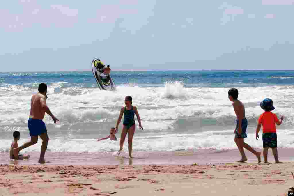 Unas personas juegan en la playa de Laguava Resort, en Rmaileh, al sur de Beirut, Líbano. Líbano, que ha tenido un número relativamente bajo de infecciones por coronavirus y sufre una crisis económica y financiera.