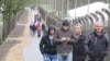 Migrants walk outside a camp in Rodgön, Germany.