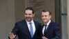 French President Emmanuel Macron, right, poses for photographers with Lebanon's Prime Minister Saad Hariri prior to their meeting at the Elysee Palace in Paris, Saturday, Nov. 18, 2017.