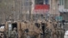 FILE - NATO soldiers inspect near the site of an attack in Kabul, Afghanistan, March 25, 2020.