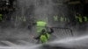 Anti-riot police use a water cannon during clashes with "yellow vest" (Gilet Jaune) protesters during a demonstration on Nov. 30, 2018, near major EU buildings in Brussels. 