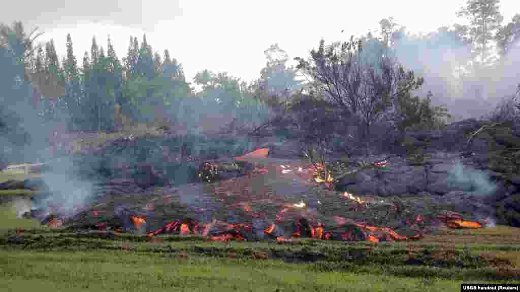 A breakout occurs from an inflated lobe of the Kilauea volcano lava flow near the village of Pahoa, Hawaii, Nov. 2, 2014.